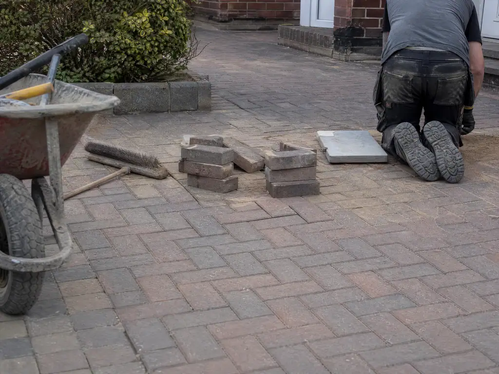 Block paving relaid neatly after a supply pipe repair under the drive, Nottingham