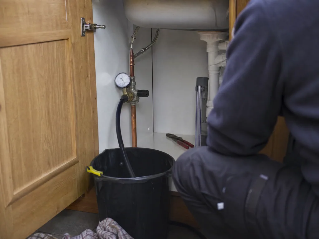 Pressure test gauge fitted under a sink to confirm a leak under the floor, Nottingham