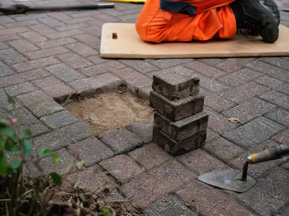 Small square of block paving lifted over a leak, blocks kept for relaying, Nottingham